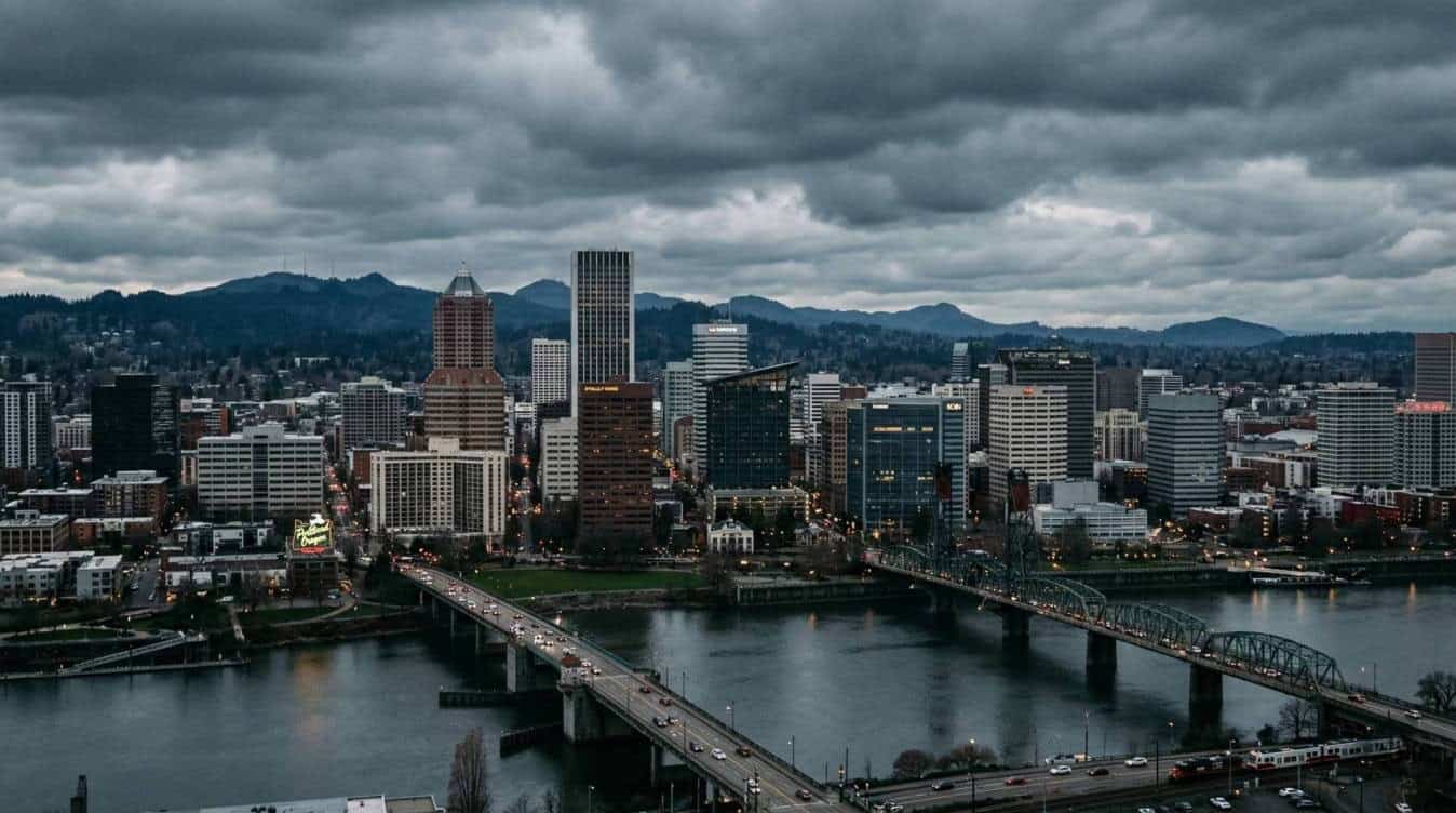 Portland Oregon downtown skyline showing urban core real estate market where investors consider 1031 exchange into zero tax Sunbelt NNN properties.